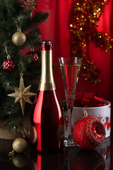 New Year background in red and gold colors. Champagne, gifts and Christmas decorations on the festive table.