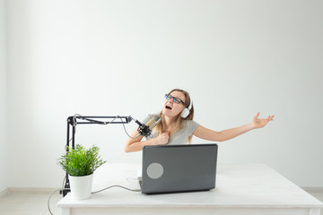 Blogger, streamer and people concept - Funny young woman DJ working on the radio