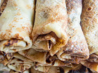 heap of folded delicious crepes filled with jam
