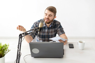 Music, dj, blogging and broadcasting concept - Male radio host with a funny expression