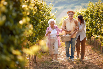 Winemaker family together in vineyard.