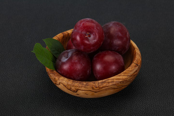 Plum heap in the wooden basket