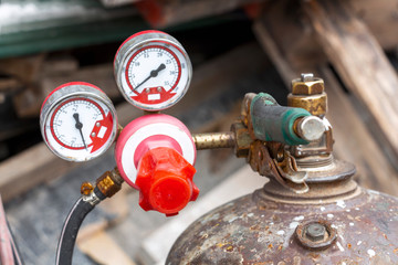 Close up of pressure gauges on oxygen tank with valve of welding equipment acetylene gas cylinder for steel Industrial and metal working construction.
