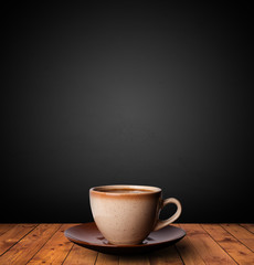 Cup of drink on wooden table with dark background
