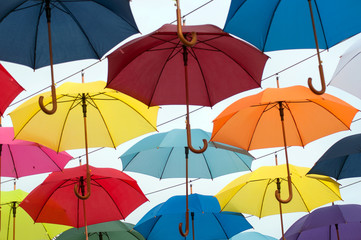 Closeup of colorful umbrella suspended in the street