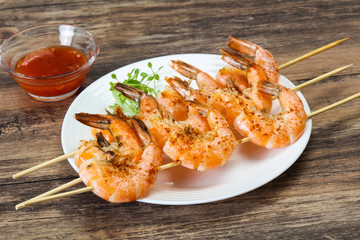 Grilled prawn skewer with sauce