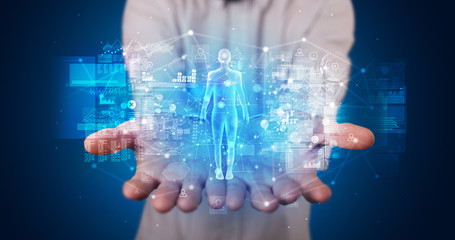 Young person holding hologram projection displaying health related graphs and symbols