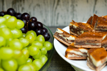 plate with sliced pie and plate with grapes close-up