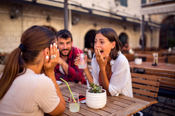 Friends talking in cafe at break