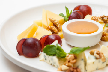 cheese plate with a honey and berries