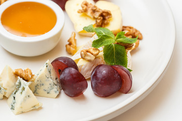 cheese plate with a honey and berries