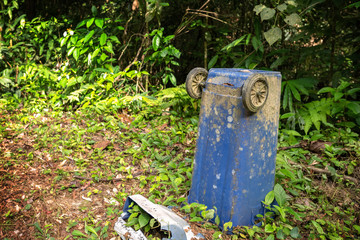 Garbage in forest in Thailand. People illegally thrown garbage into forest. Concept of man and...