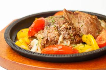 meat with vegetables on a white background
