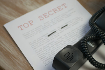 Phone off the hook with top secret document containing classified information  - obrazy, fototapety, plakaty