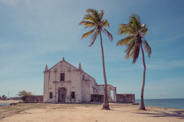 An old weathered white washed church on the beach of the Island of Mozambique (Ilha de Mocambique),...