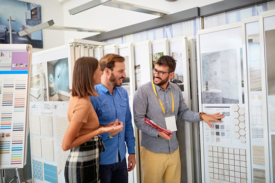 Couple with salesman in store for the house..