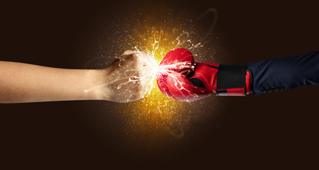Obraz na płótnie Canvas Two hands fighting with orange dust, spark, glow and smoke concept