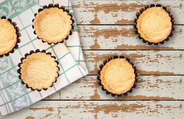 Empty Tartlets or pie isolated on wood table