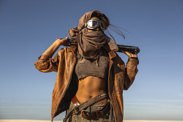 Post-apocalyptic Woman Outdoors in a Wasteland - obrazy, fototapety, plakaty