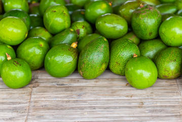 Bunch of fresh and natural green avocado sold At a farmers market