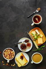 table with morning food, breakfast (tea, coffee, jam, toast, sandwich, cornflakes and more) menu concept. food background. copy save. Top view