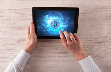 Hand working on tablet with cryptocurrency and network concept