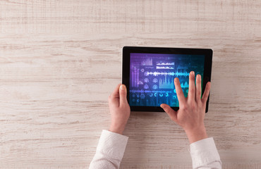 Hand touching tablet with waveforms and sound design concept