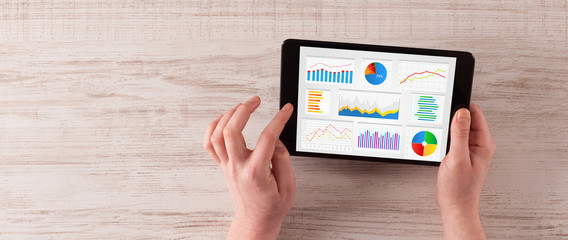 Hand making diagrams and charts on tablet