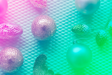 Various Christmas ornaments in open composition toned pink mint gradient