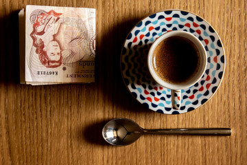 Obraz na płótnie Canvas Espresso cup from above on table with spoon and money