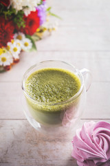 matcha latte, flowers and marshmallow on  white background , close-up, copy space