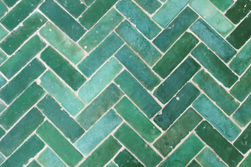 Green tile floor decorated outdoors.