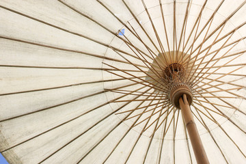 Big bamboo umbrella for outdoors with sky background. Umbrella handmade in the north of Thailand.