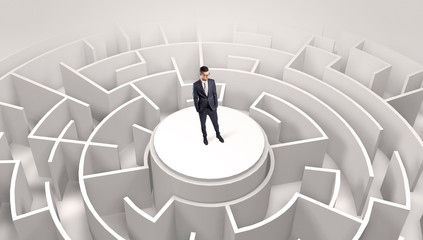 Businessman standing on the top a maze and looking through