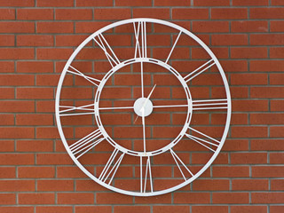 metal clock with roman numeral built on red brick