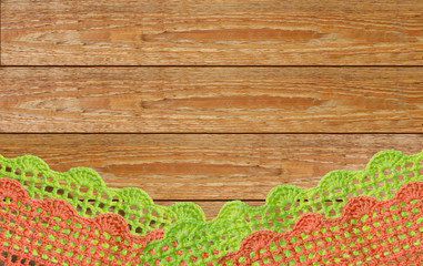 Lace knitted by hand on a wooden surface.