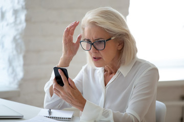 Frustrated woman hold cellphone having device troubles