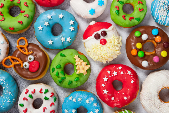 Set of Christmas donuts on gray stone background.