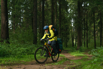 Naklejka premium cyclist hiker in the autumn forest
