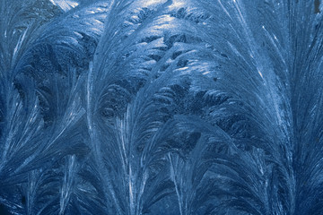 Frozen textured window glass. Winter ice frost. Winter blue ornament