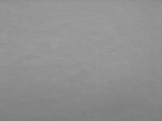 Close up mesh pattern of gray seat pad texture background inside car.