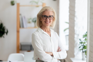 Portrait of smiling senior businesswoman posing for picture