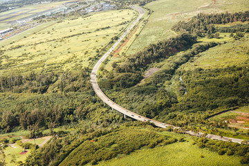 Kaumualli Highway on the island of Kauai. This is one of the main roads that starts in Lihue  near the airport and ends on the north shore of Hanalei Bay. Lush green surroundings near the highway. - 288367887