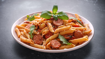 Sausage penne Pasta with tomato sauce and fresh herbs
