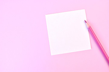 Obraz na płótnie Canvas Empty white paper with pink pencil on a pink background, as mockup for your design. Minimal composition in flat lay style. Copy space.