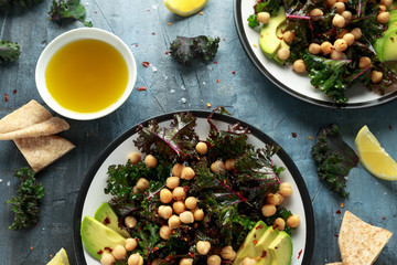 Kale Chickpeas, avocado salad with lemon on plate. healthy food.