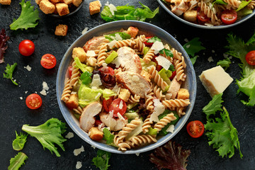 Caesar Salad Pasta with chicken, tomato, parmesan cheese and vegetables