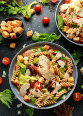 Caesar Salad Pasta with chicken, tomato, parmesan cheese and vegetables