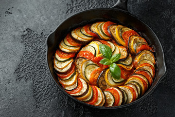 Ratatouille Vegetable Stew with zucchini, eggplants, tomatoes, garlic, onion and basil. on cast...
