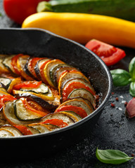 Ratatouille Vegetable Stew with zucchini, eggplants, tomatoes, garlic, onion and basil. on cast...